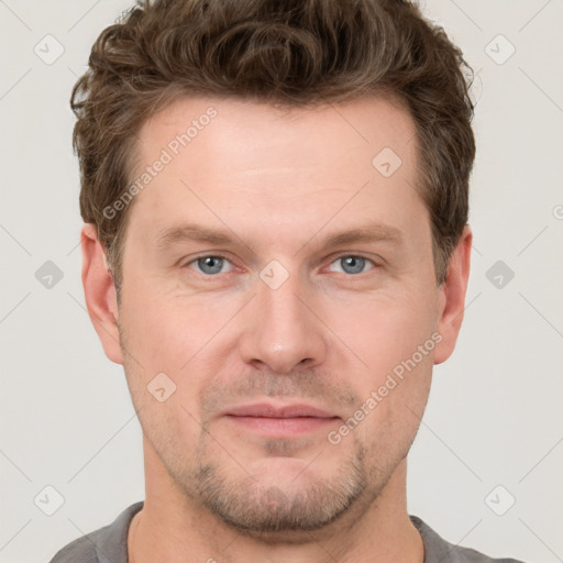 Joyful white adult male with short  brown hair and grey eyes