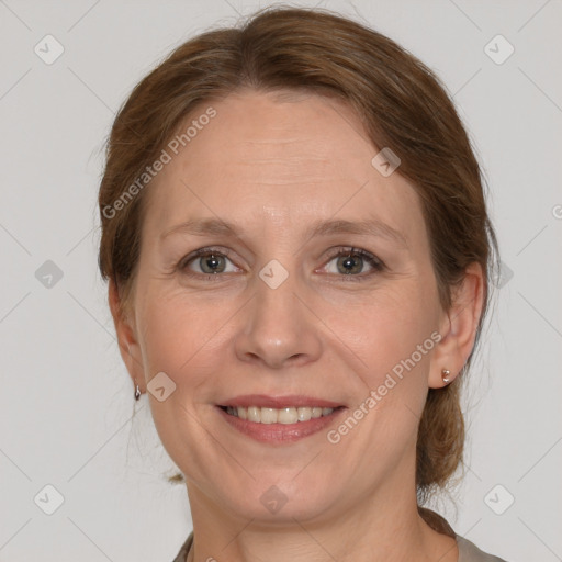 Joyful white adult female with medium  brown hair and grey eyes