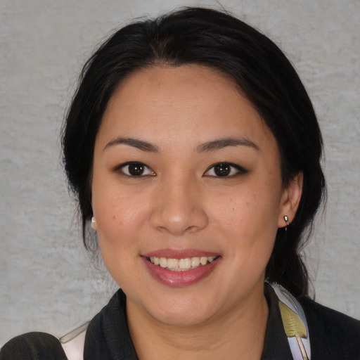 Joyful asian young-adult female with medium  black hair and brown eyes