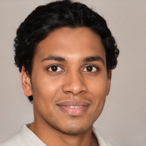 Joyful latino young-adult male with short  brown hair and brown eyes