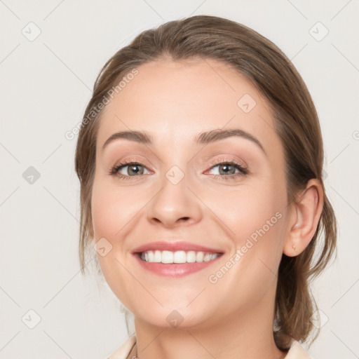 Joyful white young-adult female with medium  brown hair and blue eyes