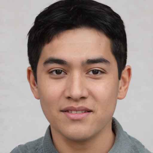 Joyful asian young-adult male with short  black hair and brown eyes