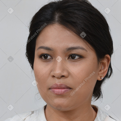 Joyful latino young-adult female with medium  brown hair and brown eyes