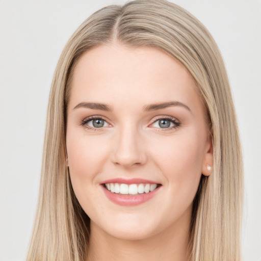 Joyful white young-adult female with long  brown hair and green eyes