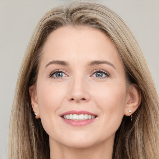 Joyful white young-adult female with long  brown hair and grey eyes