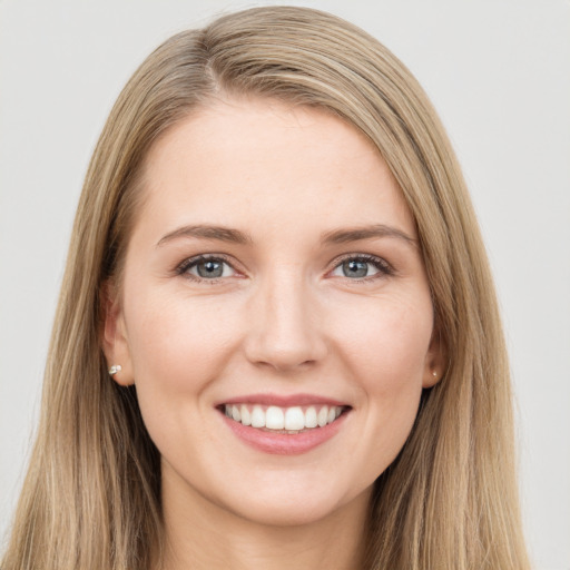 Joyful white young-adult female with long  brown hair and green eyes