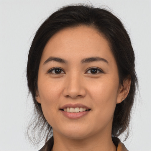 Joyful asian young-adult female with medium  brown hair and brown eyes