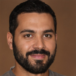 Joyful latino young-adult male with short  black hair and brown eyes