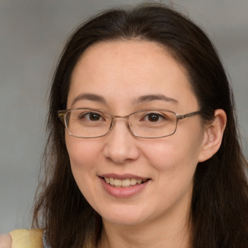 Joyful white adult female with long  brown hair and brown eyes