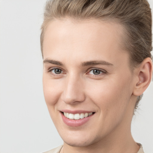 Joyful white young-adult female with short  brown hair and brown eyes