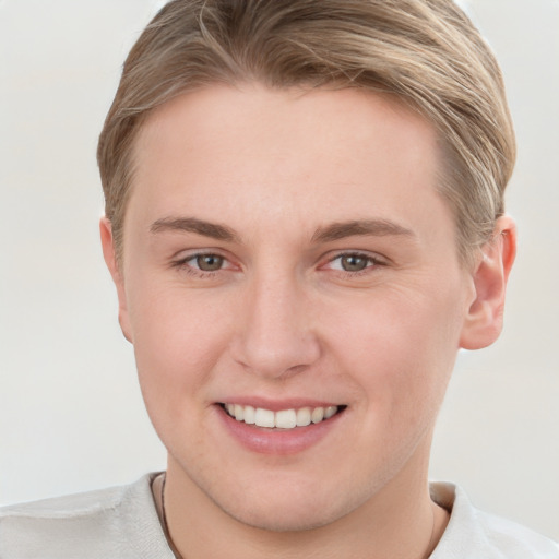 Joyful white young-adult female with short  brown hair and grey eyes