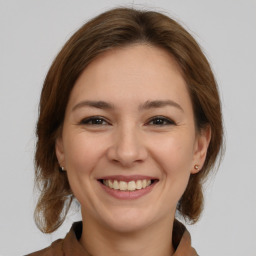 Joyful white young-adult female with medium  brown hair and brown eyes