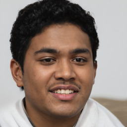 Joyful latino young-adult male with short  brown hair and brown eyes