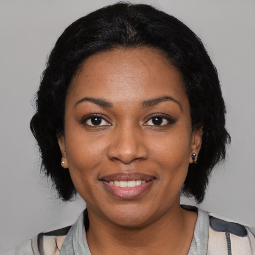 Joyful black young-adult female with medium  black hair and brown eyes