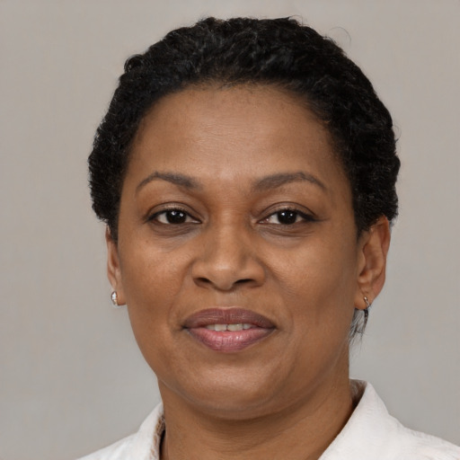 Joyful black adult female with short  brown hair and brown eyes