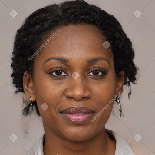 Joyful black adult female with medium  brown hair and brown eyes