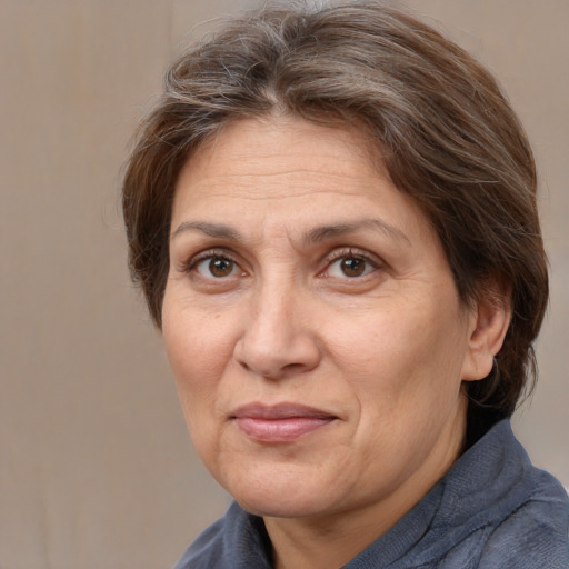 Joyful white adult female with medium  brown hair and brown eyes