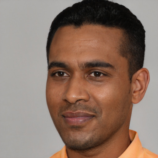 Joyful black young-adult male with short  black hair and brown eyes