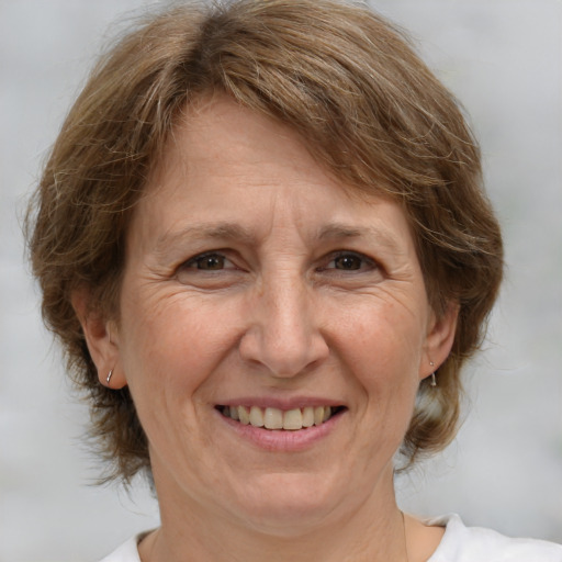 Joyful white middle-aged female with medium  brown hair and brown eyes