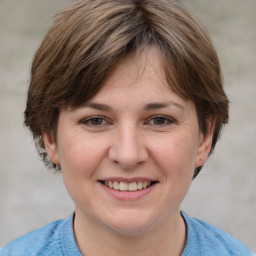 Joyful white adult female with medium  brown hair and grey eyes