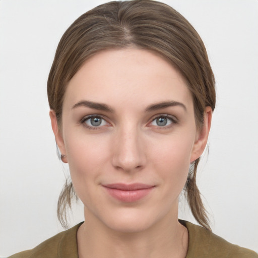 Joyful white young-adult female with medium  brown hair and grey eyes