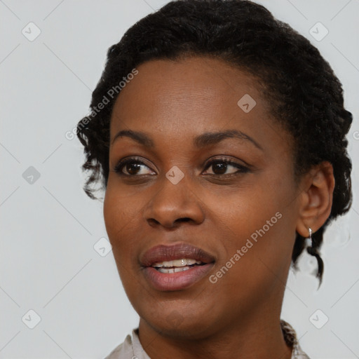 Joyful black young-adult female with short  black hair and brown eyes