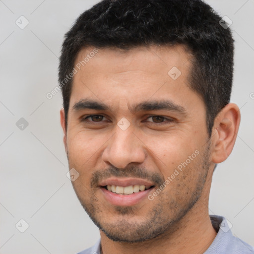 Joyful white young-adult male with short  black hair and brown eyes