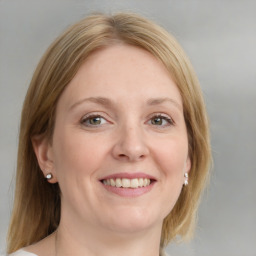 Joyful white young-adult female with medium  brown hair and blue eyes