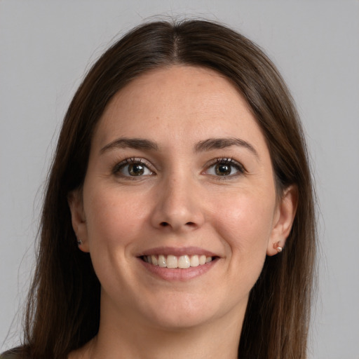 Joyful white young-adult female with long  brown hair and brown eyes