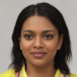 Joyful black young-adult female with medium  brown hair and brown eyes