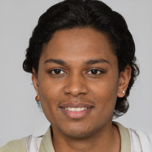 Joyful black young-adult female with short  brown hair and brown eyes