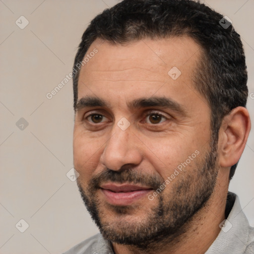 Joyful white adult male with short  black hair and brown eyes