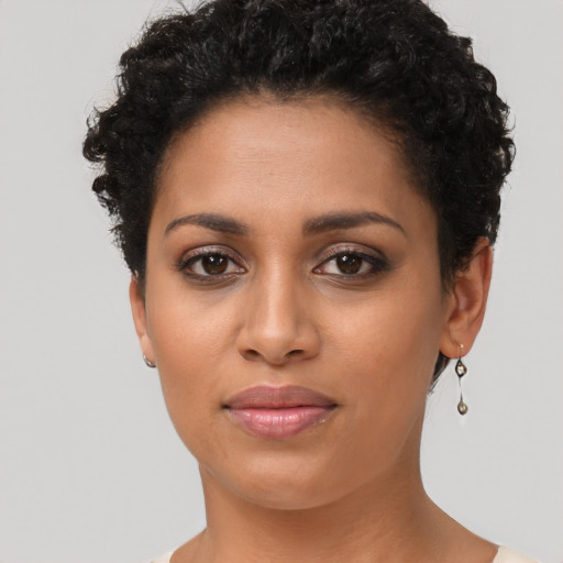 Joyful latino young-adult female with short  brown hair and brown eyes