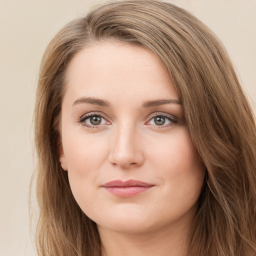 Joyful white young-adult female with long  brown hair and green eyes