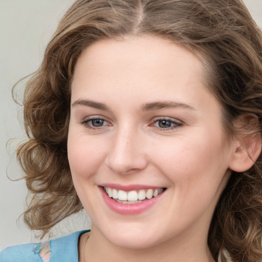 Joyful white young-adult female with medium  brown hair and green eyes