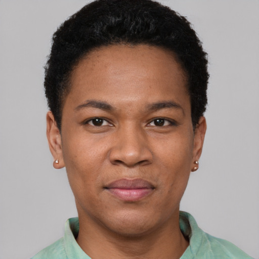Joyful black adult female with short  brown hair and brown eyes