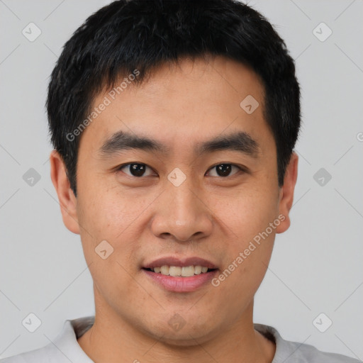 Joyful asian young-adult male with short  black hair and brown eyes