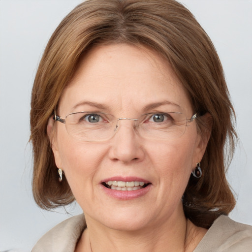 Joyful white adult female with medium  brown hair and blue eyes