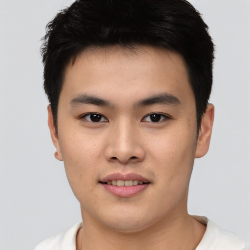 Joyful asian young-adult male with short  brown hair and brown eyes