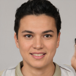 Joyful latino young-adult male with short  brown hair and brown eyes