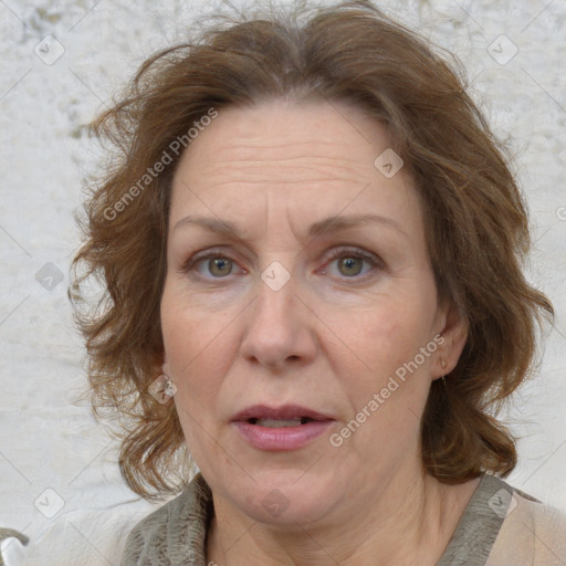 Joyful white adult female with medium  brown hair and blue eyes