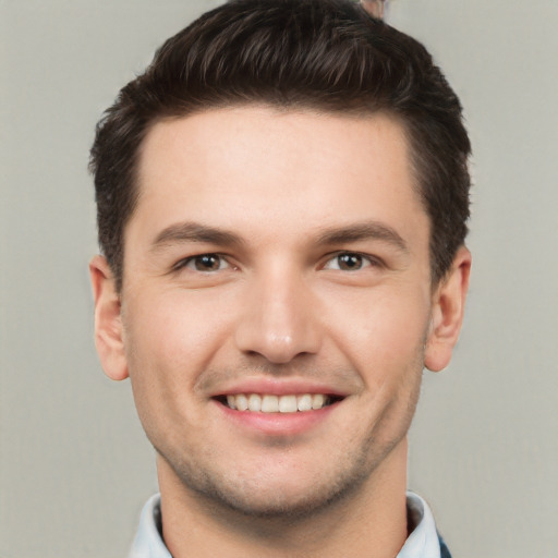 Joyful white young-adult male with short  brown hair and brown eyes