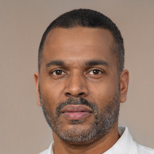 Neutral latino adult male with short  black hair and brown eyes
