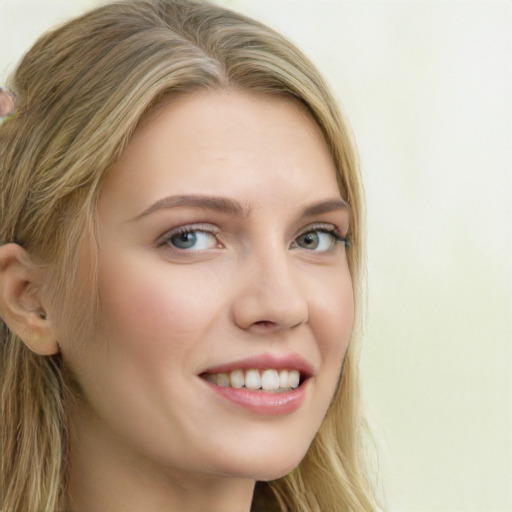 Joyful white young-adult female with long  brown hair and blue eyes