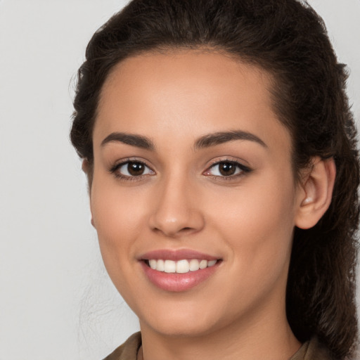 Joyful white young-adult female with long  brown hair and brown eyes