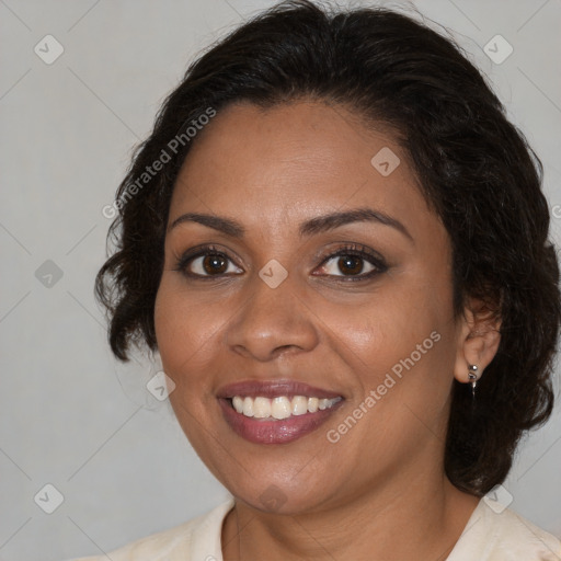 Joyful black adult female with medium  brown hair and brown eyes