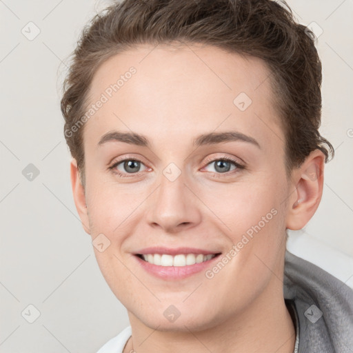 Joyful white young-adult female with short  brown hair and grey eyes