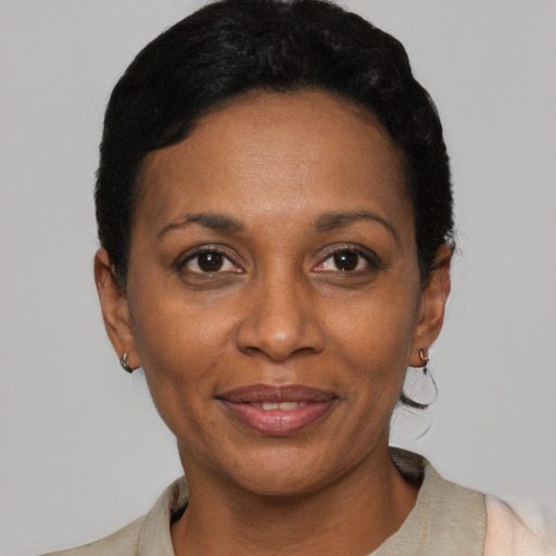 Joyful latino adult female with short  black hair and brown eyes