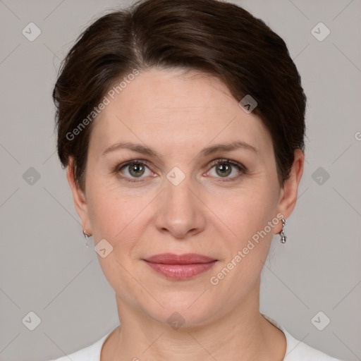 Joyful white adult female with short  brown hair and grey eyes