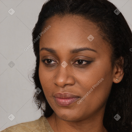 Joyful black young-adult female with long  black hair and brown eyes